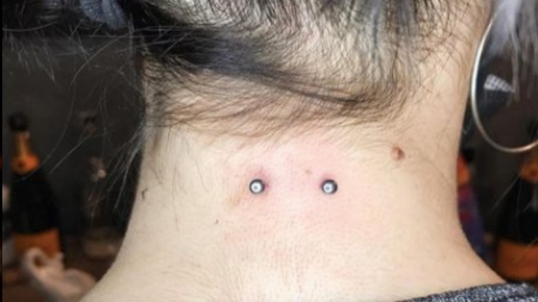woman with nape piercing