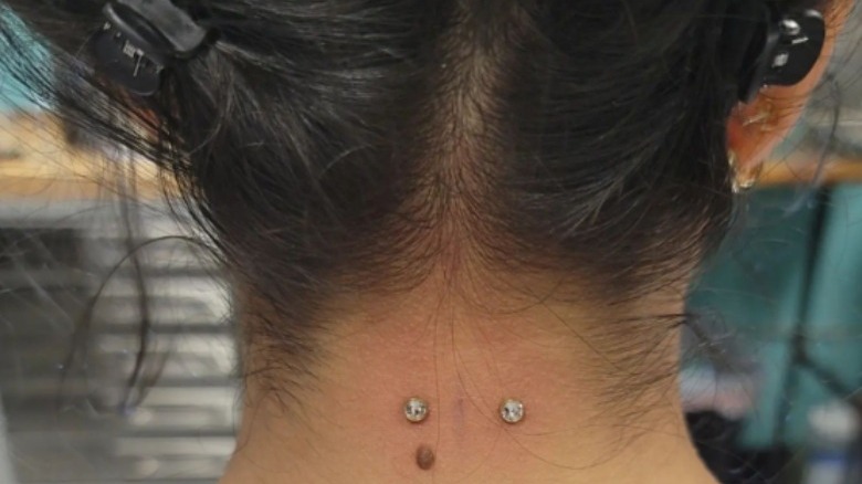 woman with new nape piercing
