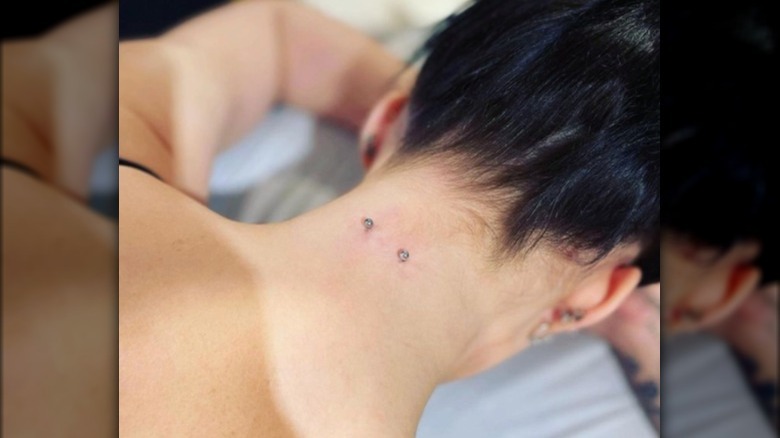 woman with new nape piercing