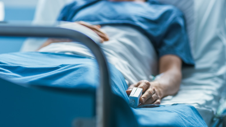 Man in hospital bed post-surgery