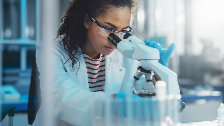 Woman looking at something under a microscope