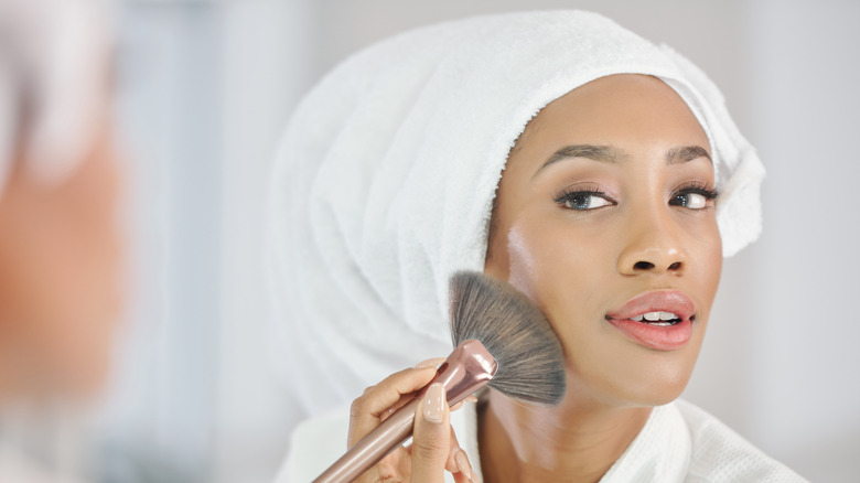 woman applying highlighter