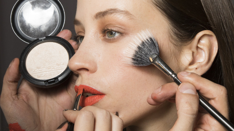 woman getting makeup done