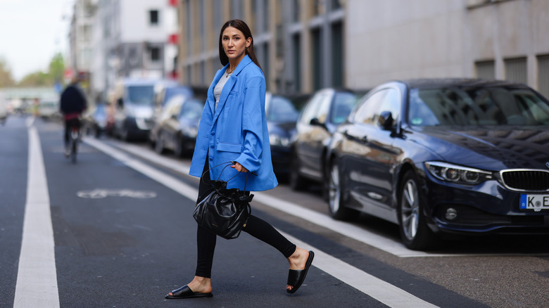 Person in blue blazer and slides