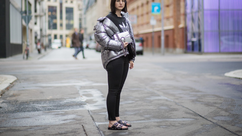 Person in puffer coat and slides