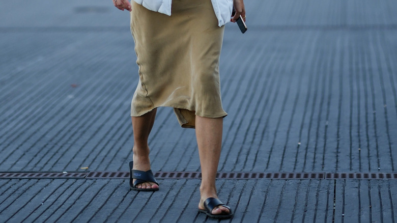 Person in midi skirt and slides