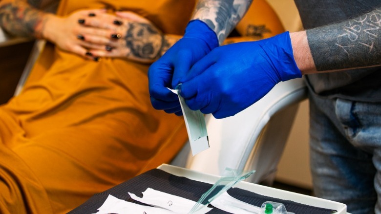 Professional piercer preparing tools 