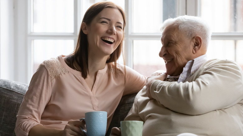 Woman laughing with father