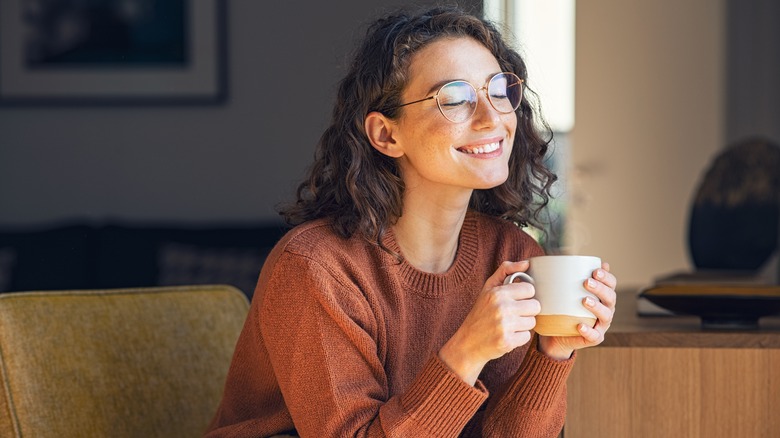 Woman smiling and drinking tea