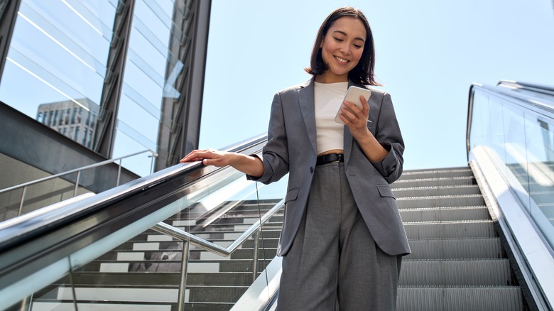 Business woman smiling at cell phone