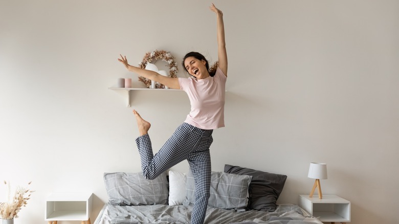 Woman dancing on bed