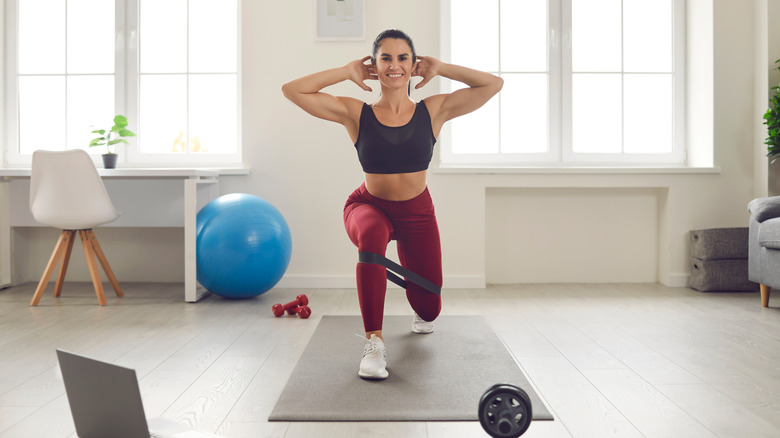 Woman doing lunges at home 