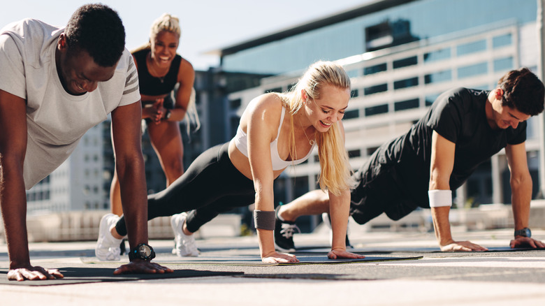 Group doing push-ups outside