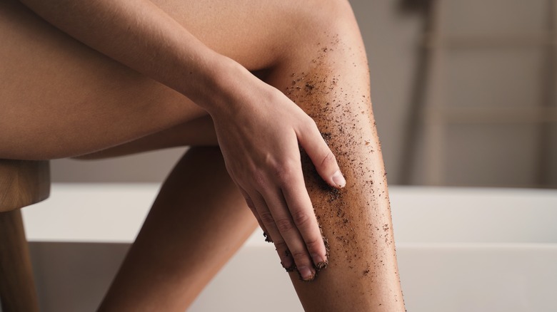 woman exfoliating legs