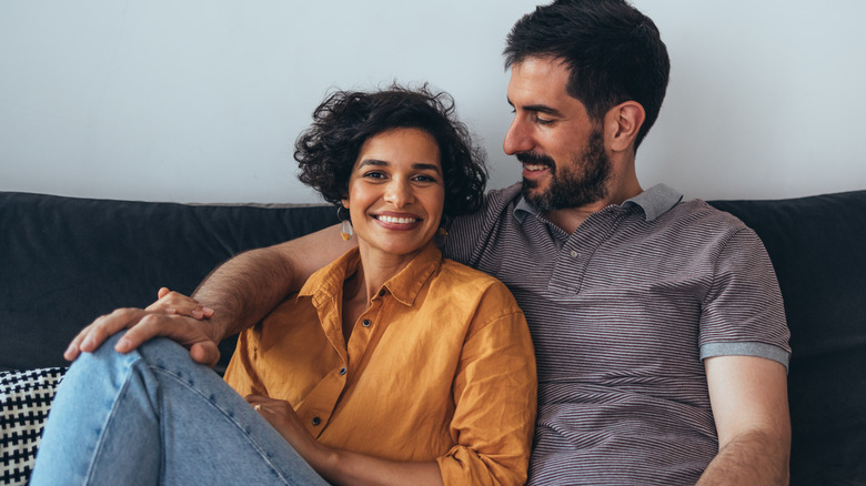 couple relaxing on sofa