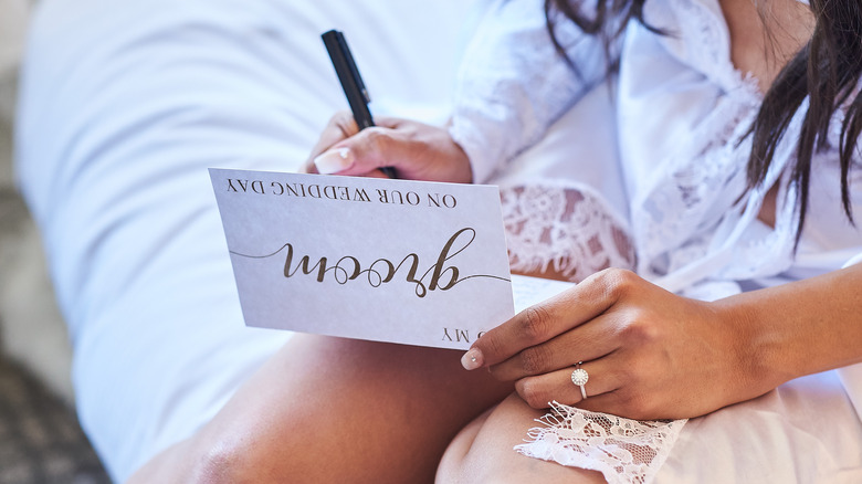bride writing her wedding vows 