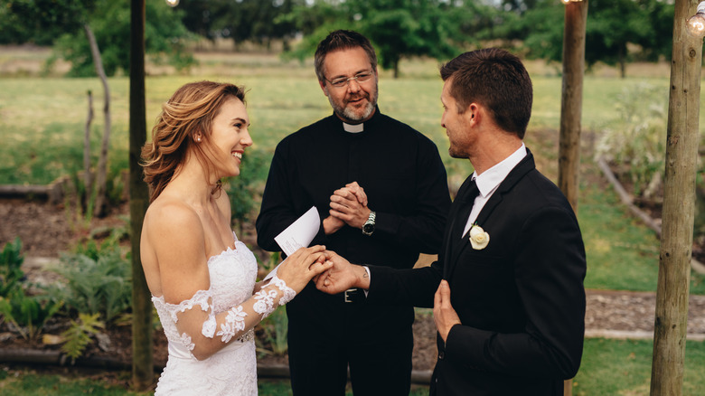 couple exchanging wedding vows outside