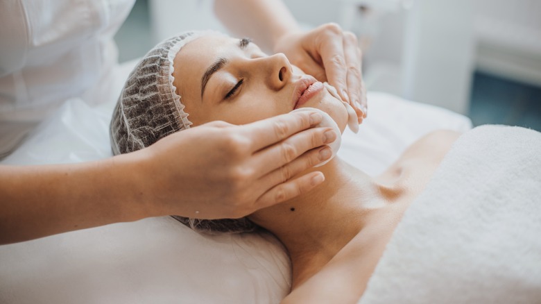 woman receiving professional facial massage