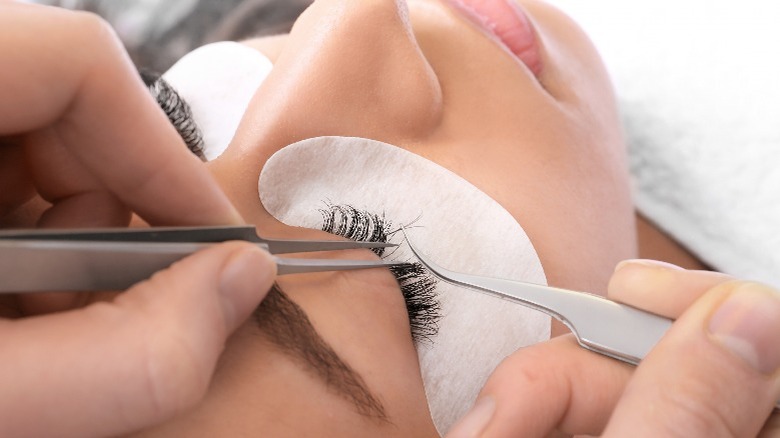 Woman receiving lash extensions