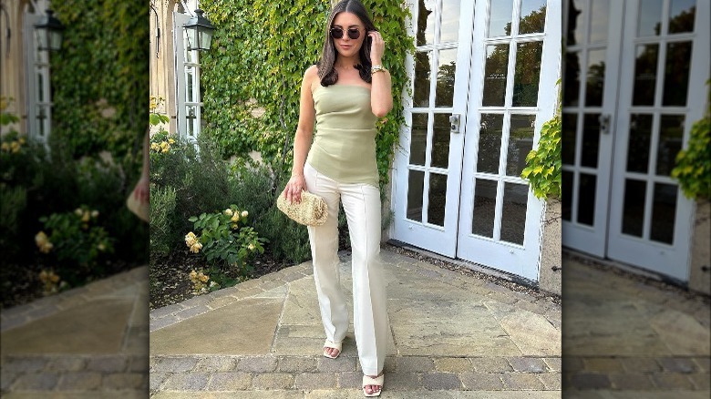 Woman wearing white tailored trousers