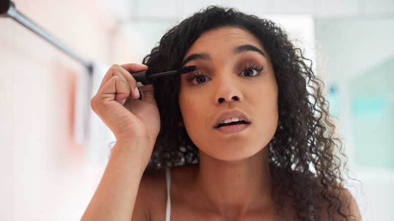 Woman applying mascara