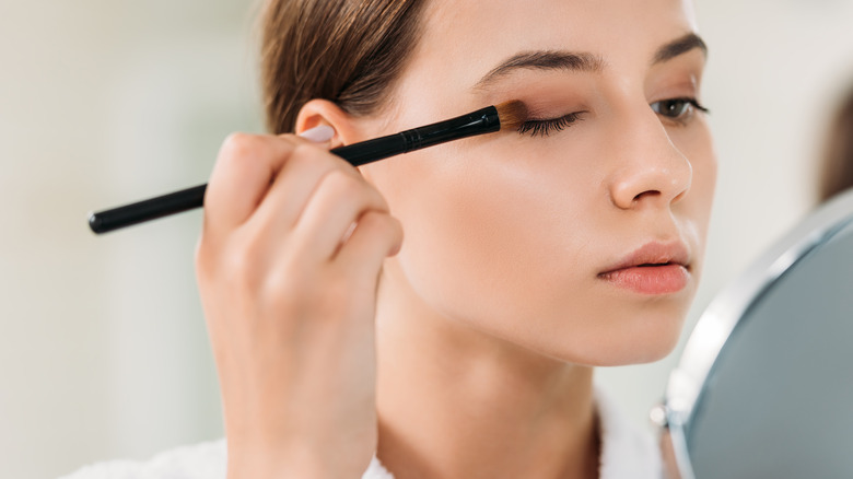 Woman applying eyeshadow