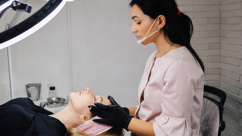 Doctor prepares for eyebrow procedure