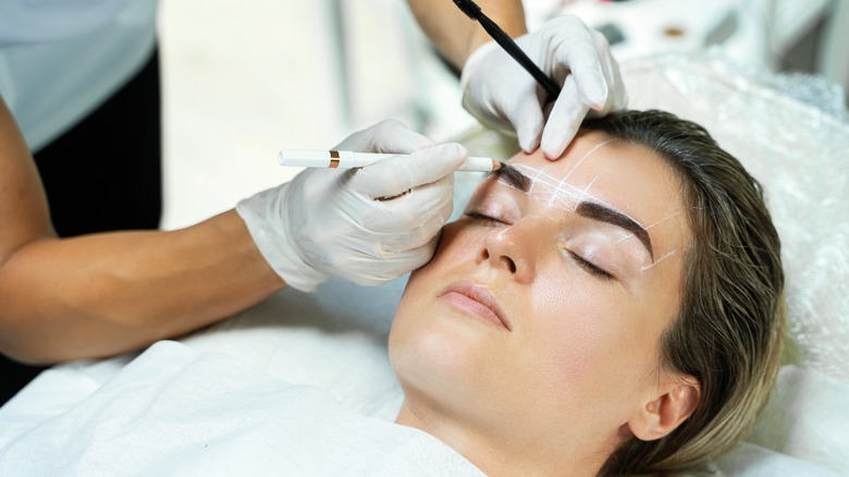 Woman having brow mapping done