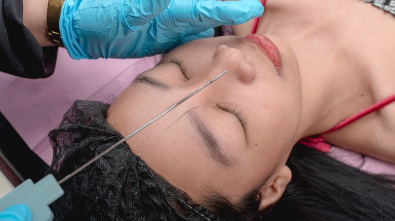 Woman having brow mapping done