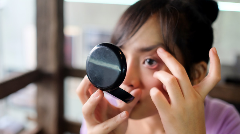 young woman looking at eyelid