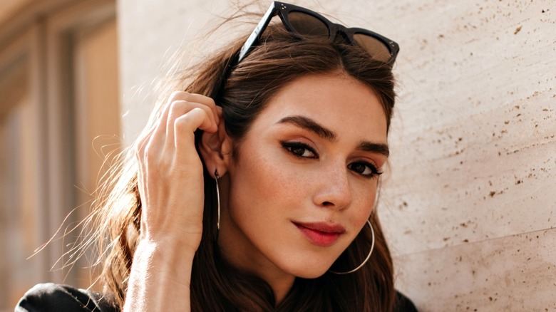 A woman wearing smudged black eyeliner all around her eyes.