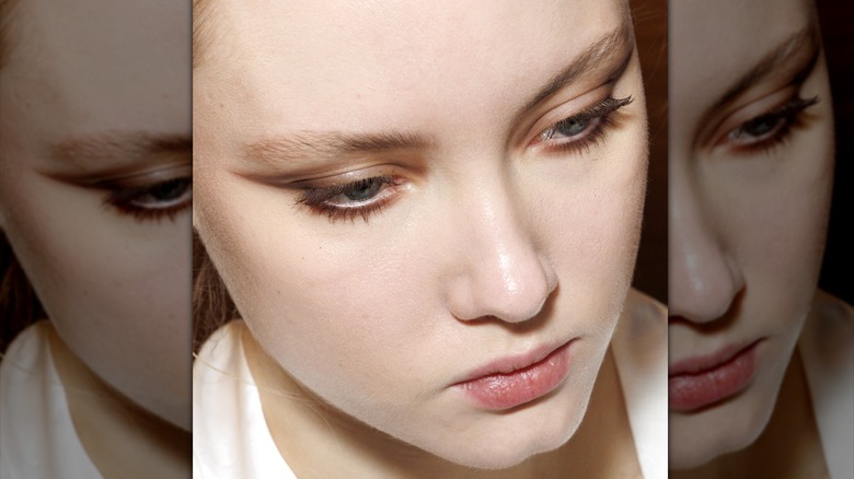 A model wearing soft brown eyeliner.