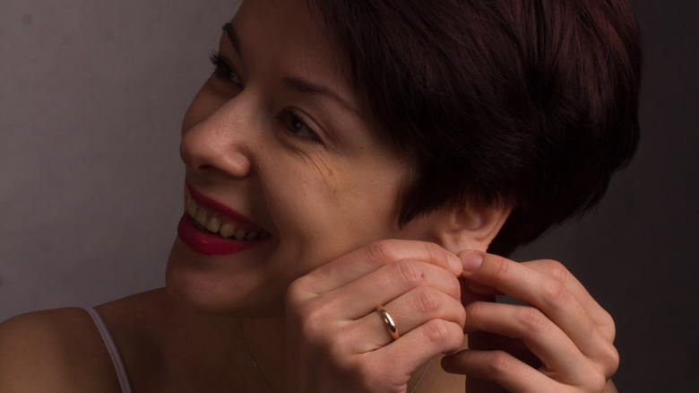 woman pulling earlobe