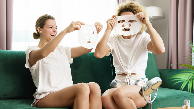 Women applying sheet masks together