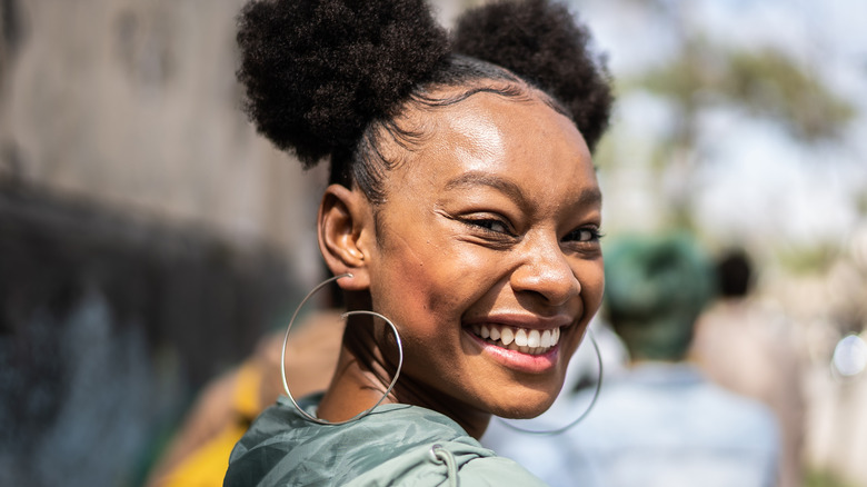 Smiling woman with space buns