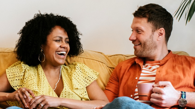 Man and woman chatting on sofa