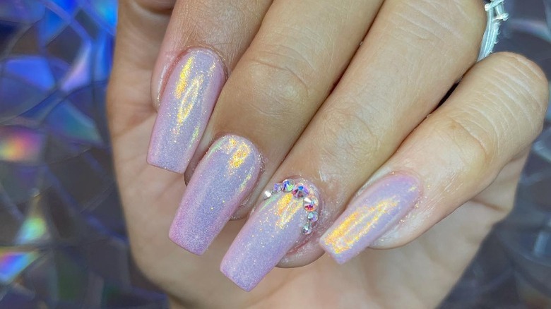 close up on glitter nails with gems 