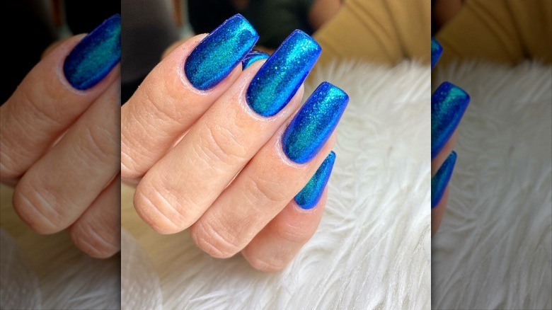 close up on vibrant blue glitter nails 