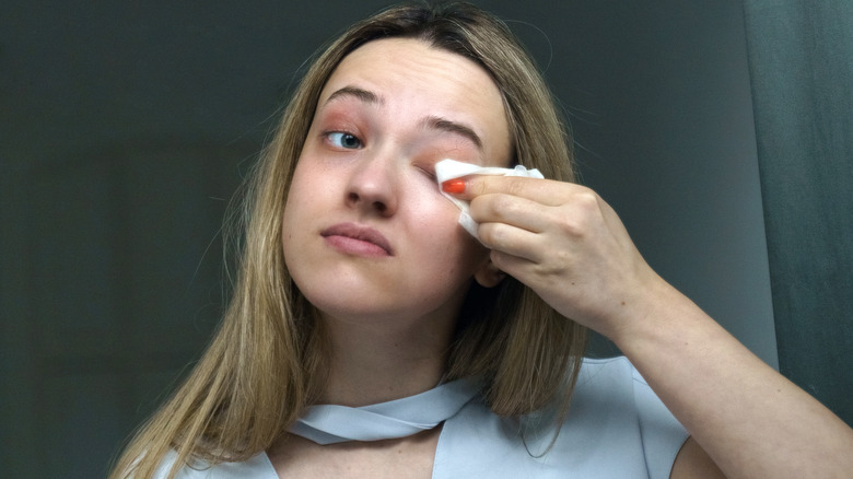 Woman wiping off makeup