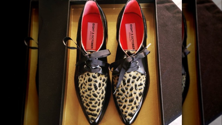 Black shoes with animal print fur accents 