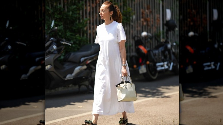 Person in white dress with sandals