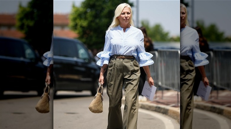 Person in trousers and blue blouse