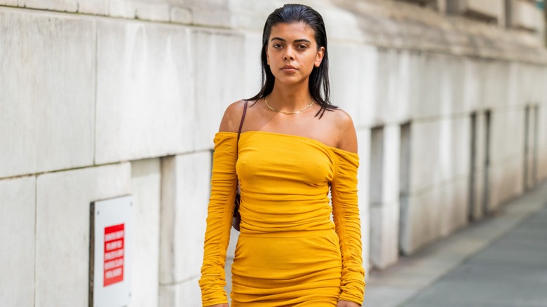 Woman wearing yellow off-the-shoulder dress