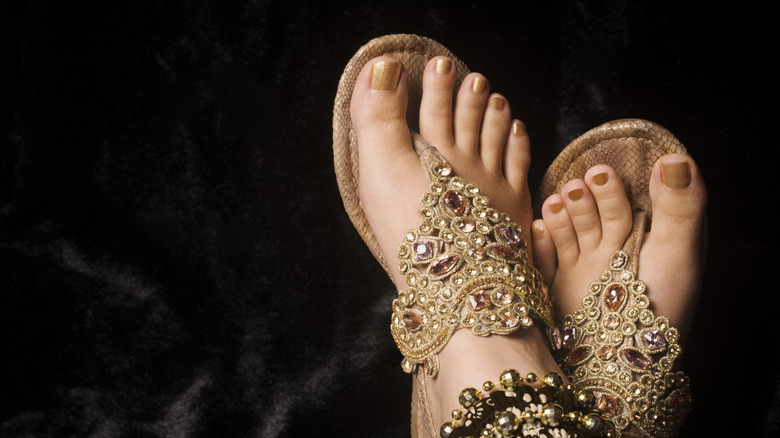Fancy gold flip-flops, matching pedicure