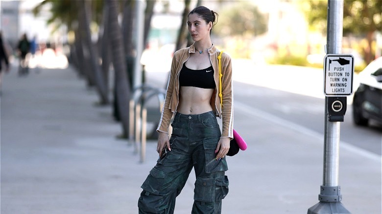 Fashionable girl in crop top and cargo pants