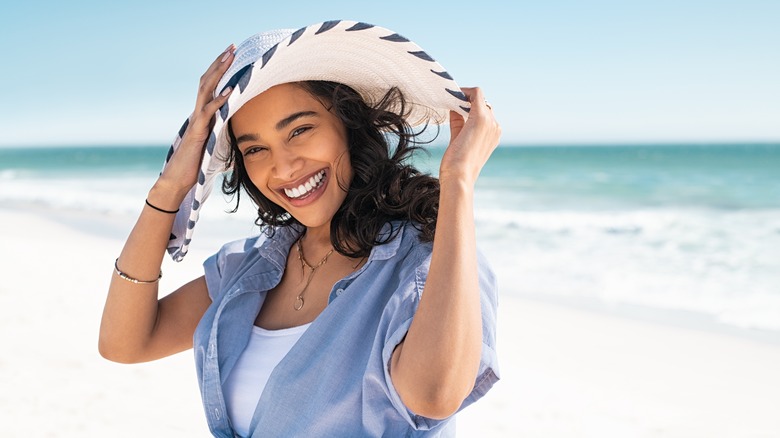 Woman wearing sun hat on beach