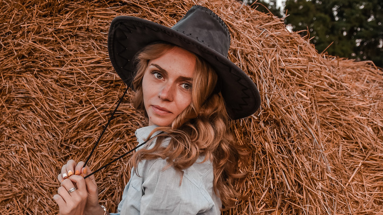 Woman on farm wearing hat