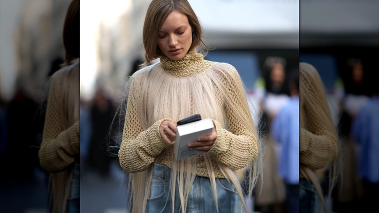 Woman wearing fringe collar over turtleneck