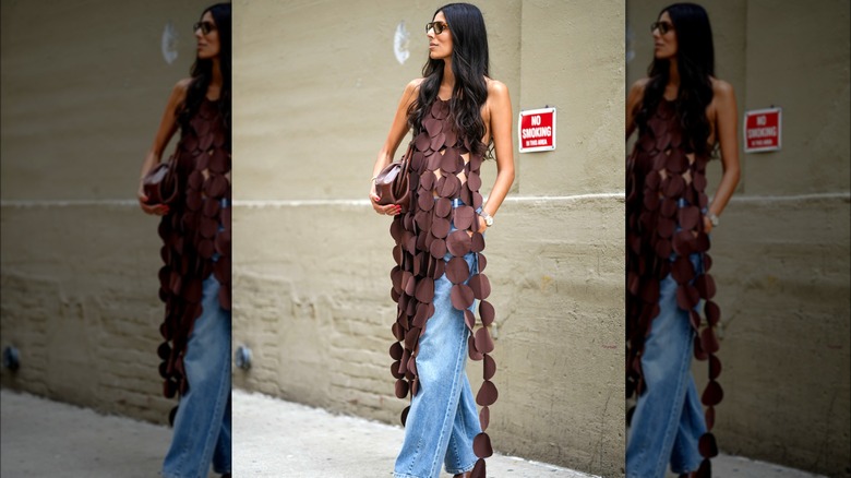 Woman wearing blouse with fringe of circle cutouts