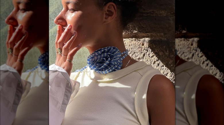 Woman wearing wrap-around flower neck piece